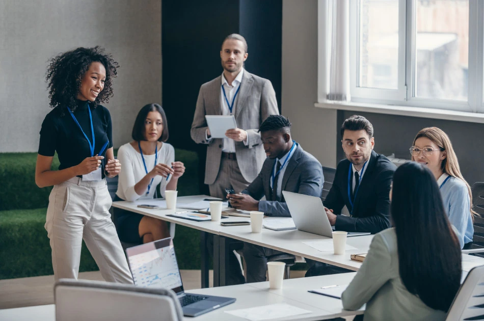 Smiling African female speaker talking to audience during a business conference in office Smiling African female speaker talking to audience during a business conference in office