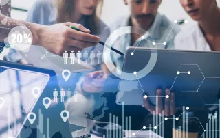 colleagues gathered around tablet doing analysis